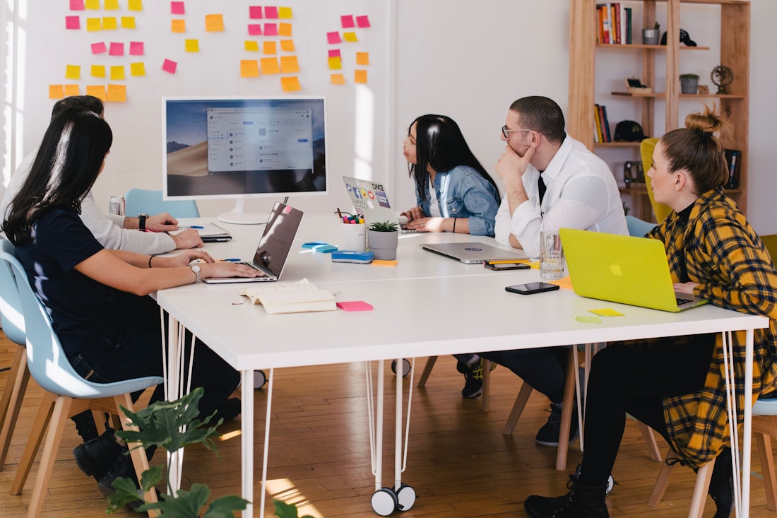 A team working through content strategy around a table in a modern workspace